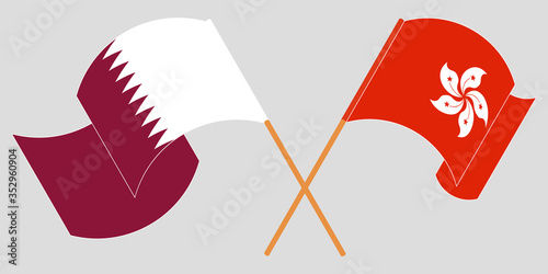 Crossed and waving flags of Hong Kong and Qatar