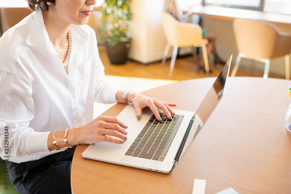 Woman using laptop in coworking office space Woman using laptop in coworking office space