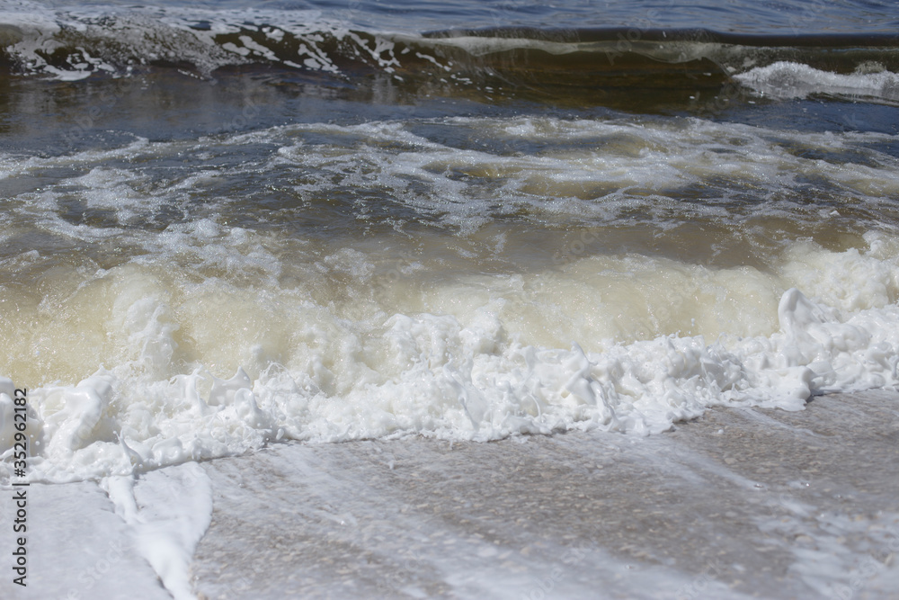 River bank, clear water and white thick foam from the surf. River bank, clear water and white thick foam from the surf.