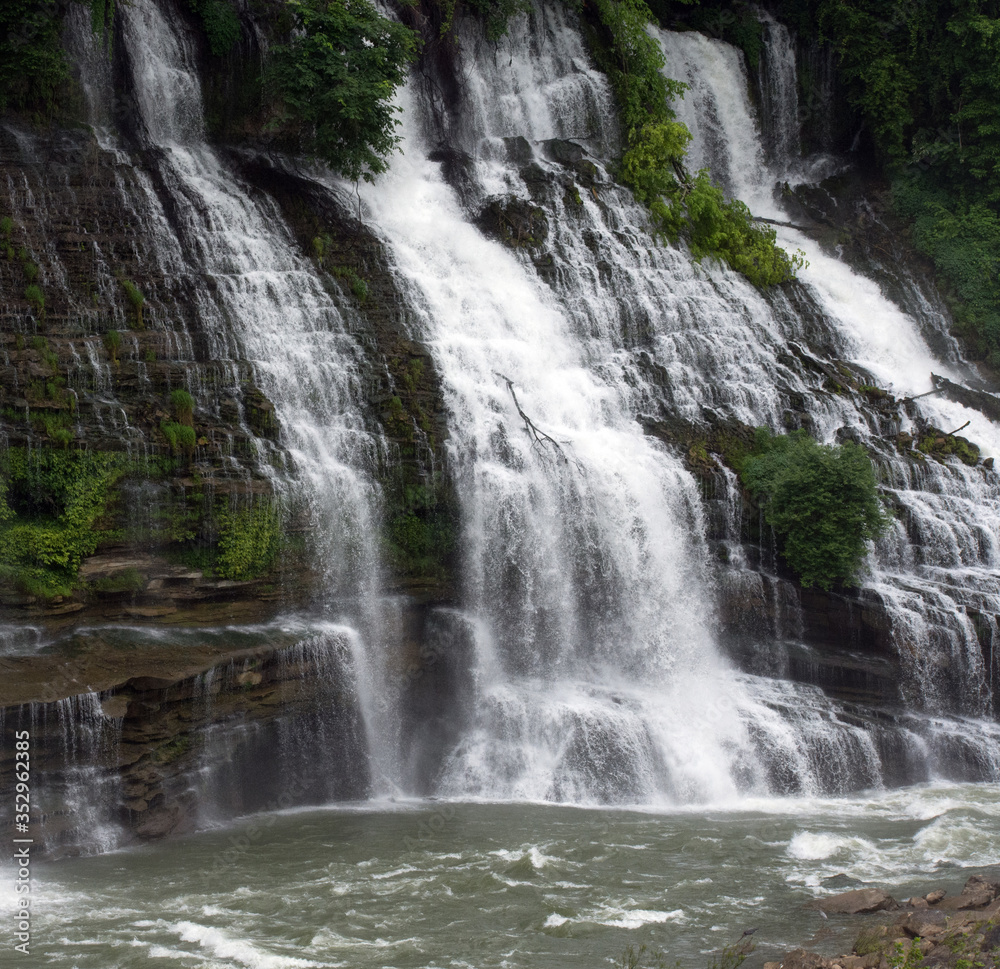 Large waterfalls flowing over rock ledges.