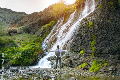 happy man and waterfall