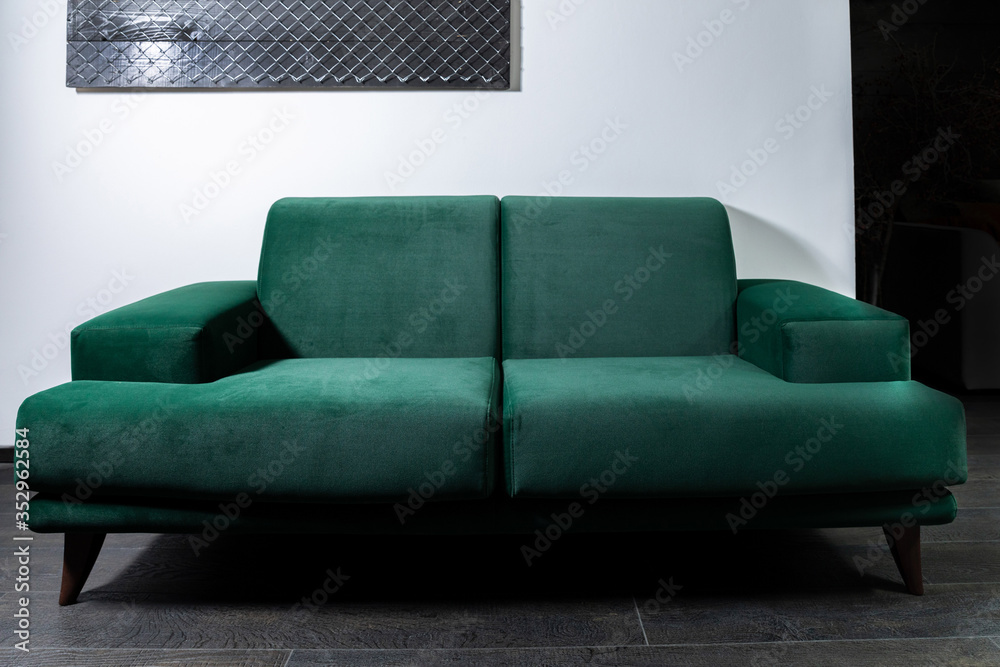 Green Sofa in the room with white walls