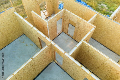 Construction of new and modern modular house. Walls made from composite wooden sip panels with styrofoam insulation inside. Building new frame of energy efficient home concept. photo