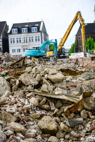 Digger demolishing houses for reconstruction
