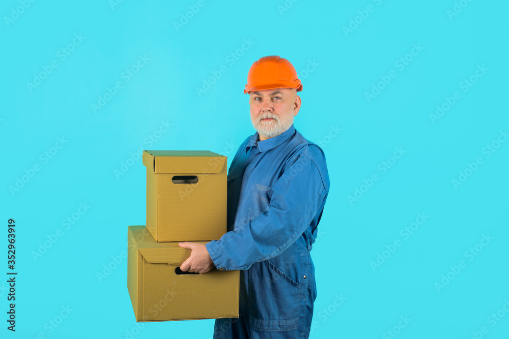 Delivery service, mail, shipment. Delivery e-commerce concept. Delivery man with parcel. Man holds cardboard box. Delivery from shop. Bearded man carry boxes. Delivery service, mail, shipment. Delivery e-commerce concept. Delivery man with parcel. Man holds cardboard box. Delivery from shop. Bearded man carry boxes.