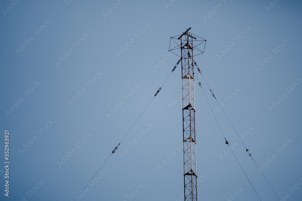 Radio antenna photographed with day light on clear sky.