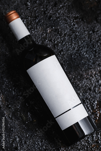 Obraz na płótnie Photo of a bottle of wine on black isolated background. w salonie