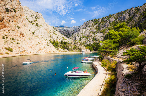 Scenic summer vacation scenery with tourists relaxing and swimming, Croatia photo