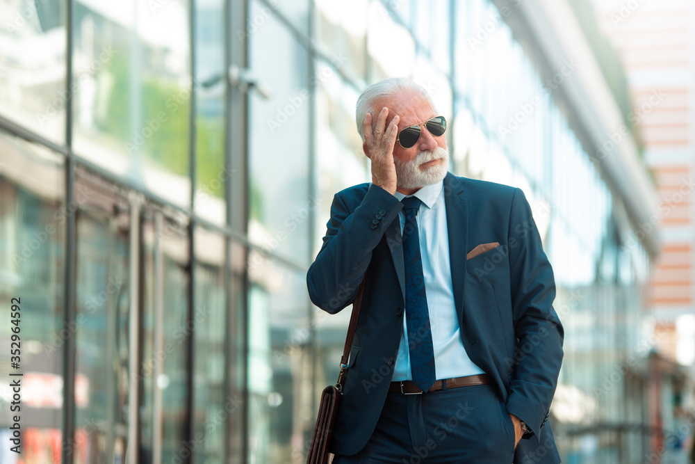 Fototapeta premium Stressed businessmen walking outdoor. Senior businessmen having a problem at work