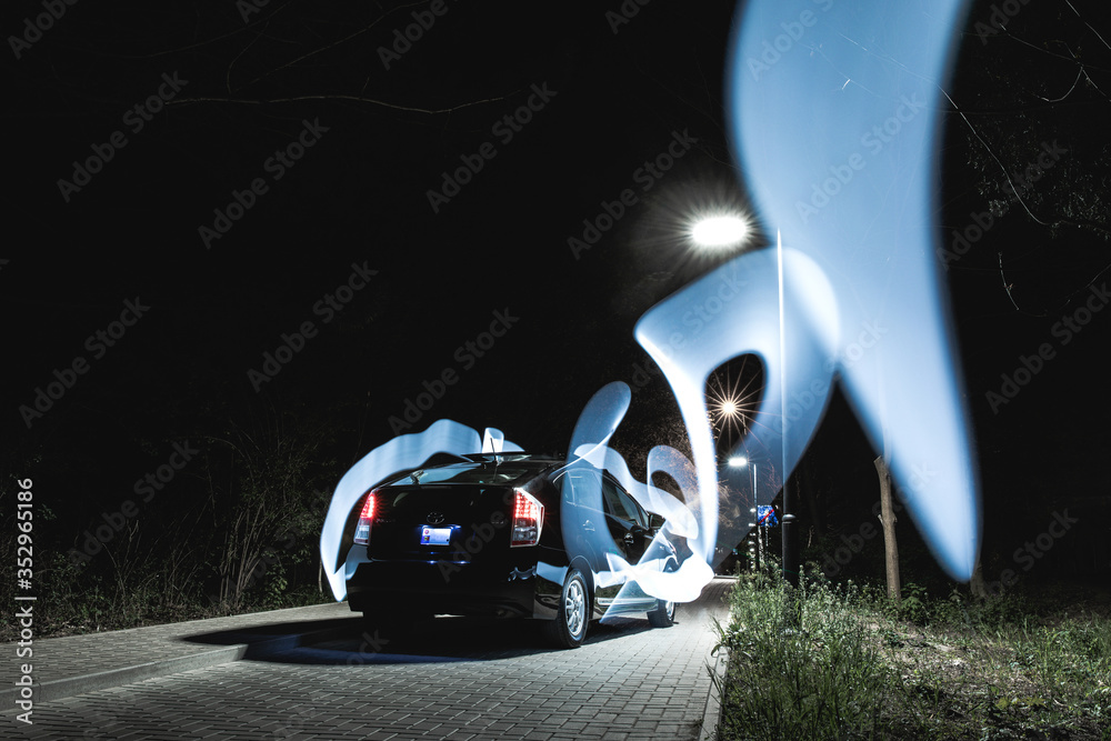 Night photography of a black car with special natural visual effects.