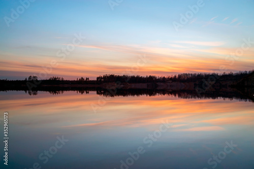 Spring sunset over the lake in calm weather . Vsevolozhsk. Leningrad region .