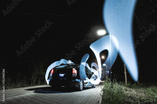 Obraz na płótnie Night photography of a black car with special natural visual effects. w salonie