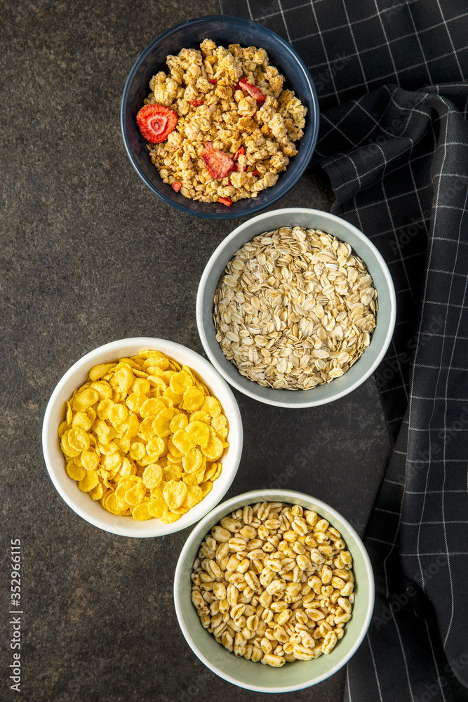 Various breakfast cereals in bowls. Puffed wheat and oatmeals. Various breakfast cereals in bowls. Puffed wheat and oatmeals.
