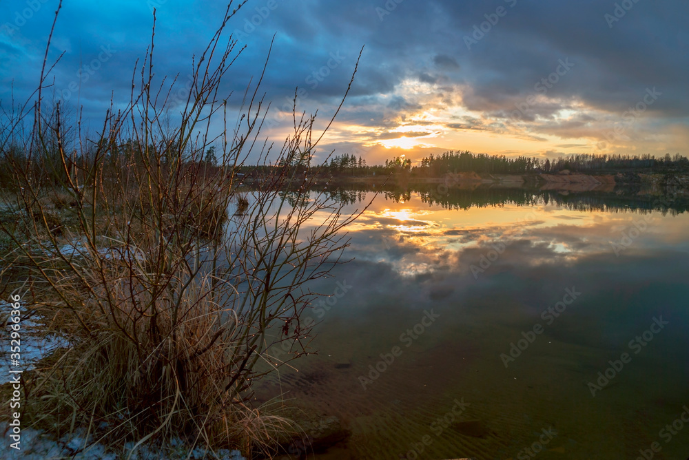 Spring sunset over the lake in calm weather . Vsevolozhsk. Leningrad region . Spring sunset over the lake in calm weather . Vsevolozhsk. Leningrad region .
