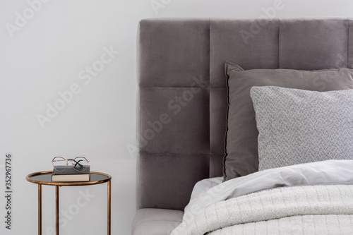 Bed with round bedside table