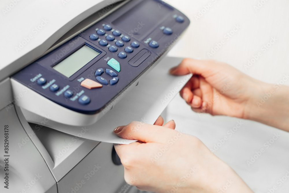 Hand press button on panel of printer. printer scanner laser office copy machine supplies start concept Hand press button on panel of printer. printer scanner laser office copy machine supplies start concept