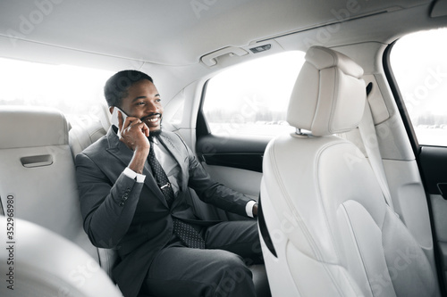 Successful Businessman Talking On Phone Sitting In Luxury Car