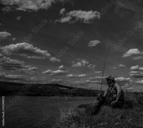 A man alone fly fishing on a wild trout stream.