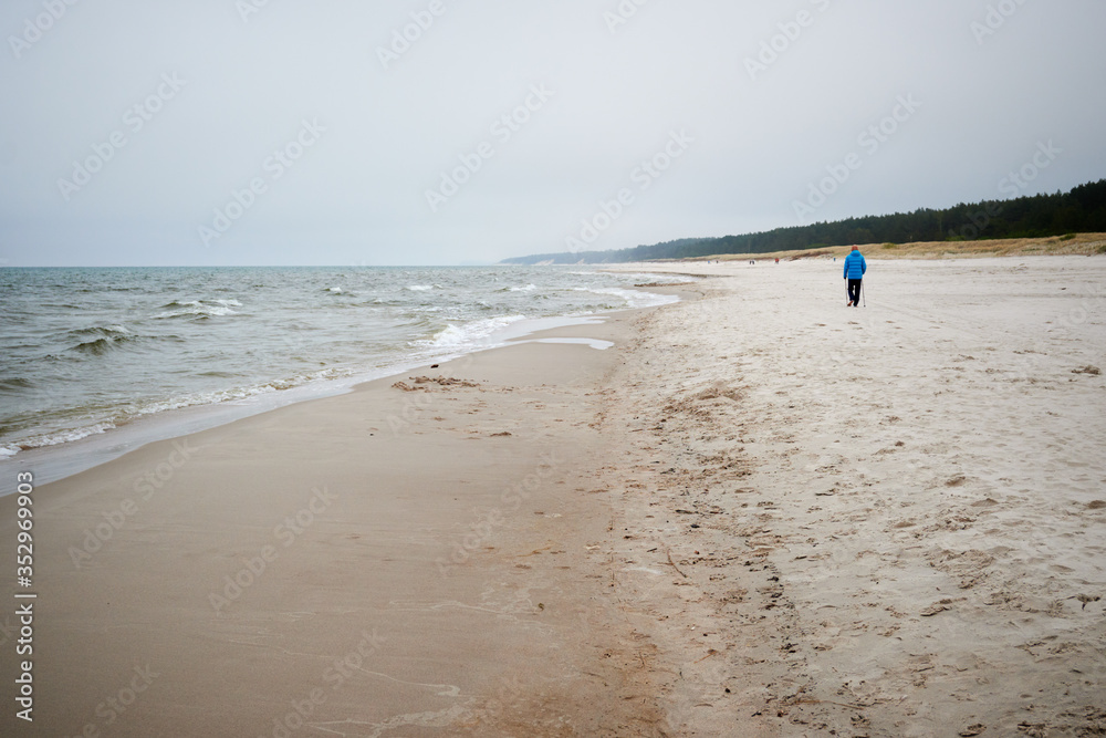 Sandy beach and Baltic Sea on a cloudy and foggy day. Poland