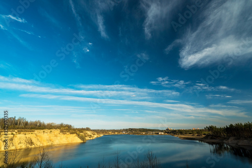 Feather clouds in the blue sky above the quarry during the day.