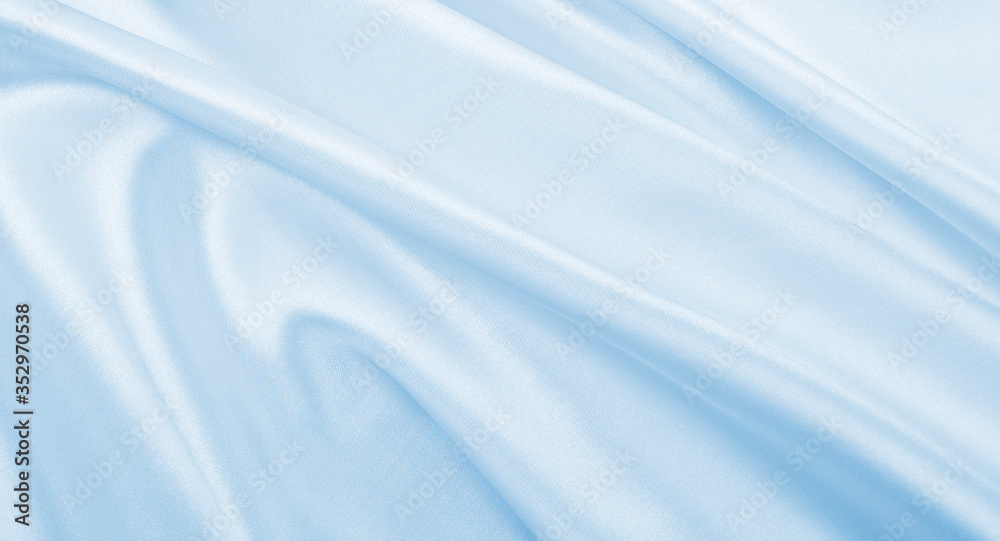 Smooth elegant blue silk or satin luxury cloth texture as abstract background. Luxurious background design Smooth elegant blue silk or satin luxury cloth texture as abstract background. Luxurious background design