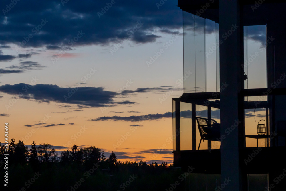 Finnish sunset and balcony silhouette with no people in Southern Finland