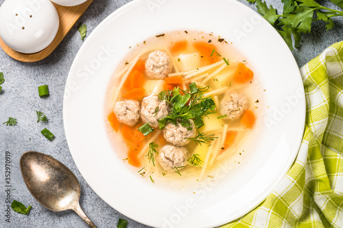 Meatballs soup with vegetables top view.