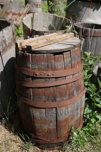 Old wooden barrels standing in the grass