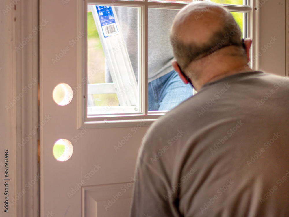Fototapeta premium men replacing door; repair and construction on door frame