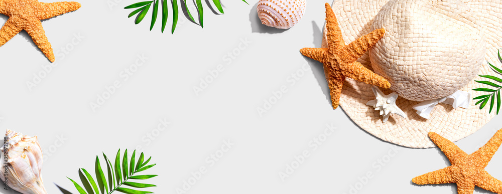 Summer concept with a straw hat and starfish overhead view - flat lay - obrazy, fototapety, plakaty 