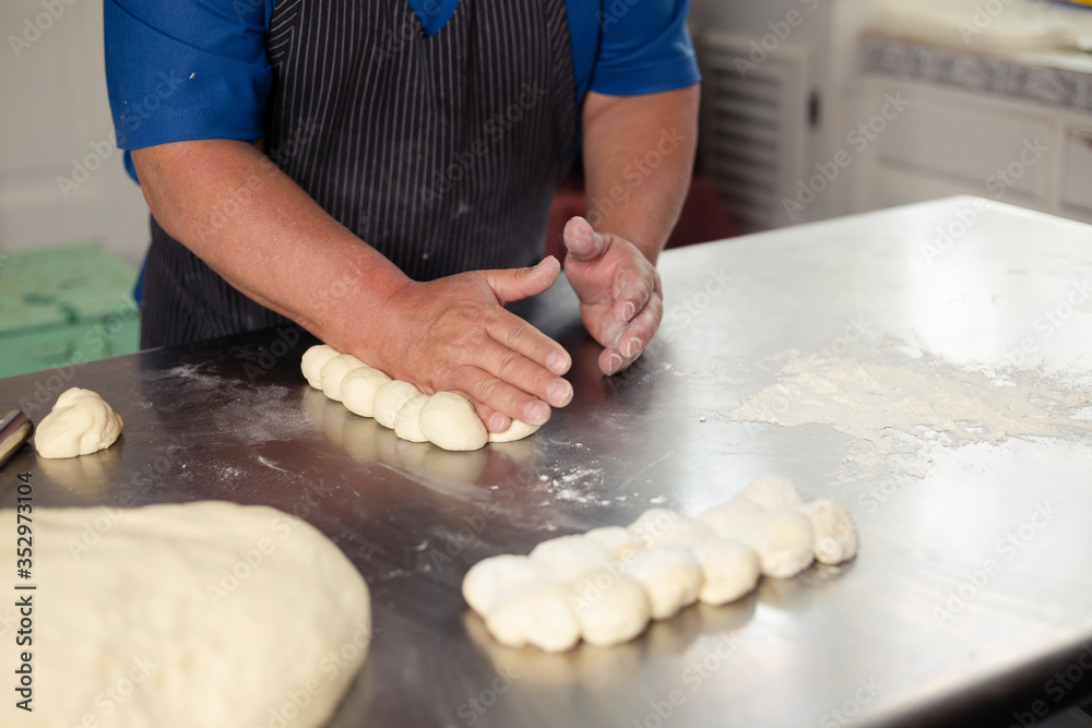 Detail of male hands preparing bread dough - baked wheat bread - Happy Hispanic adult man preparing bread dough