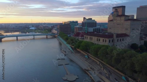 Drone Panning towards dayton at sunrise while tilting downward. Beautiful colorful sunrise on warm summer morning. Dayton riverscape and skyline