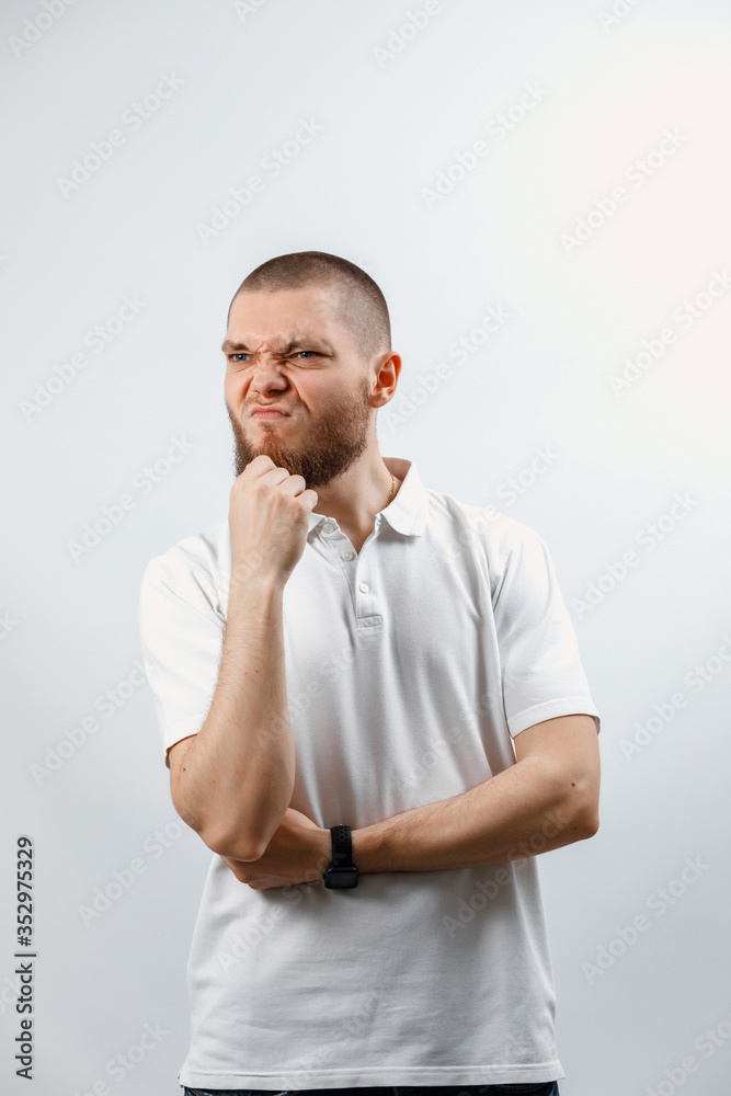 Portrait of a handsome young man looking attentively to the side on a white background. isolated. Portrait of a handsome young man looking attentively to the side on a white background. isolated.