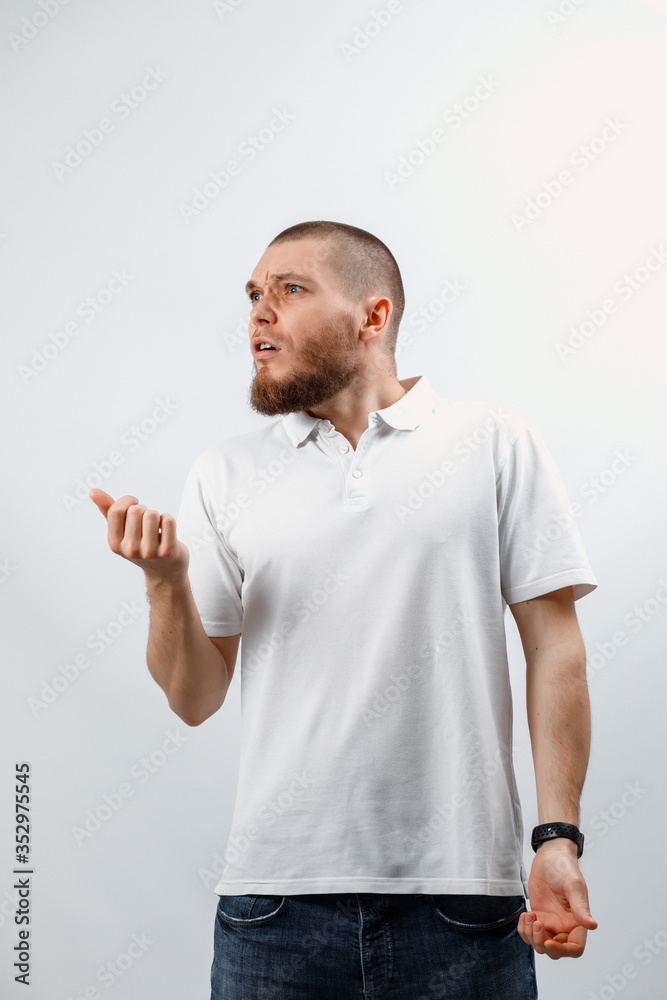 Portrait of a happy handsome young man looks away with surprise. isolated Portrait of a happy handsome young man looks away with surprise. isolated