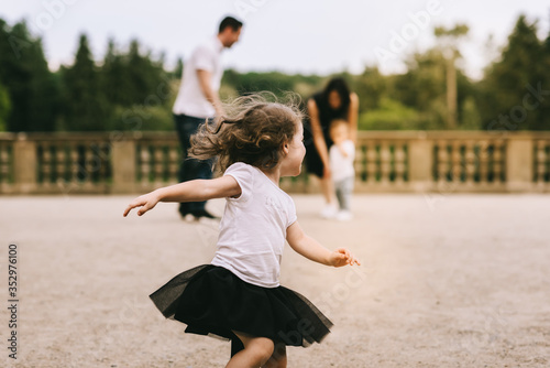 Photography Handsome young father and beautiful mother in sunny summer nature playing with t