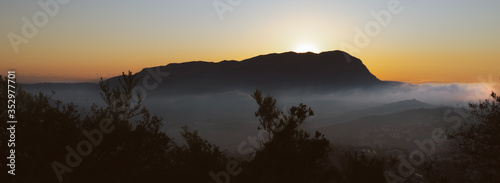 Golden sunrise in mountain. Sunrise with fog in mountain. Alicante, Gata de Gorgos, Montgo photo