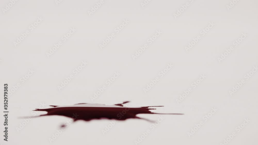 Isolated red drops of blood on white paper, macro Isolated red drops of blood on white paper, macro