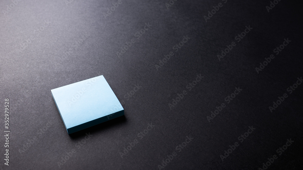 Blue square paper on black texture background, desk from top view, copy space. Blue square paper on black texture background, desk from top view, copy space.