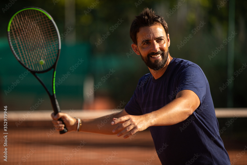 tennis player smiling and playing tennis