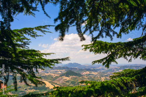 View of the mountains of San Marino through green pine branches