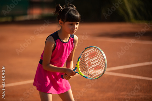 portrait of a smiling and happy young tennis player