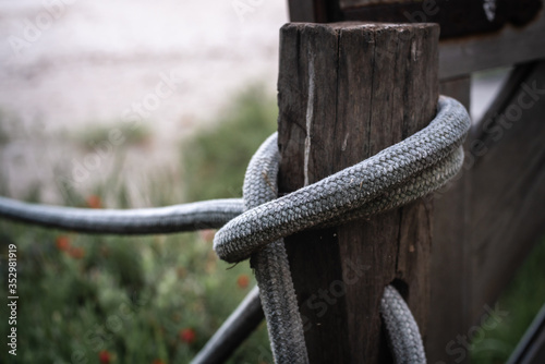Old loose rope knot on wooden plank