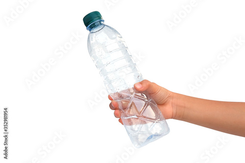 Hand, holding empty plastic bottle isolated on white background.