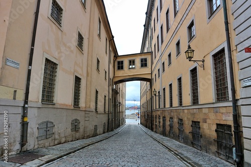 Stockholm   Sweden - 7 May 2020  Narrow alley with window bridge connecting buildings in gamla stan empty no people deserted