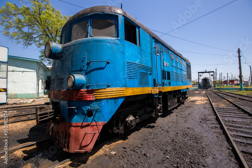Ussuriysky Locomotive Repair Plant. An old locomotive car is being repaired in a railway depot