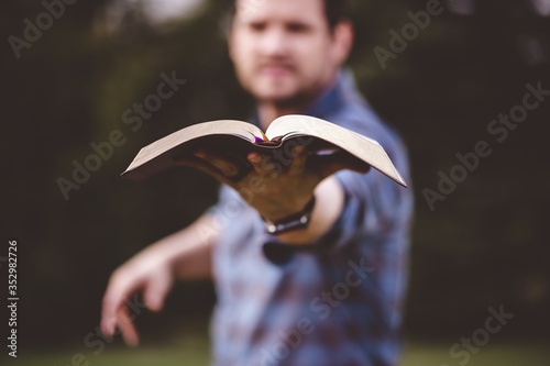 Canvas Print Male holding the Holy Bible and preaching it with a lot of enthusiasm