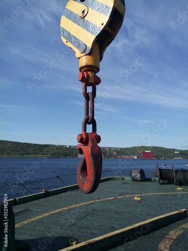 cargo hook with swivel of ship's crane on blue sky background 