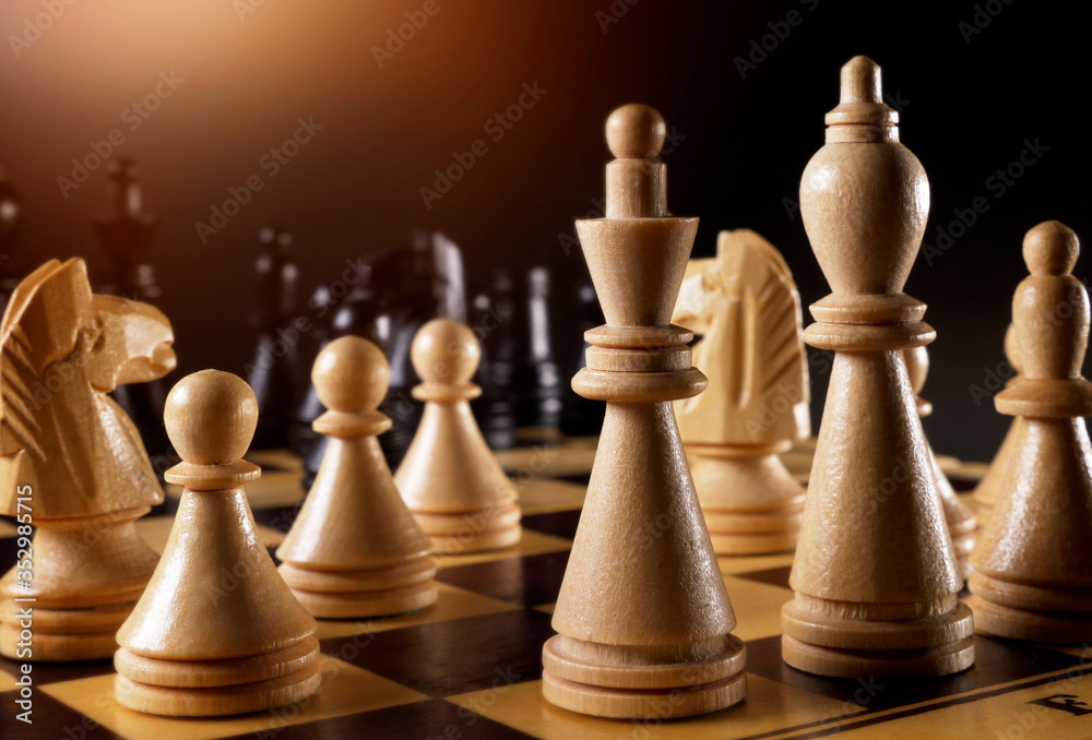Wooden chess pieces on the chessboard