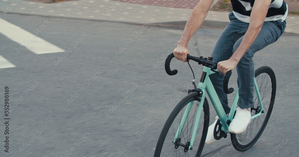 Fototapeta premium Young hipster man riding bike