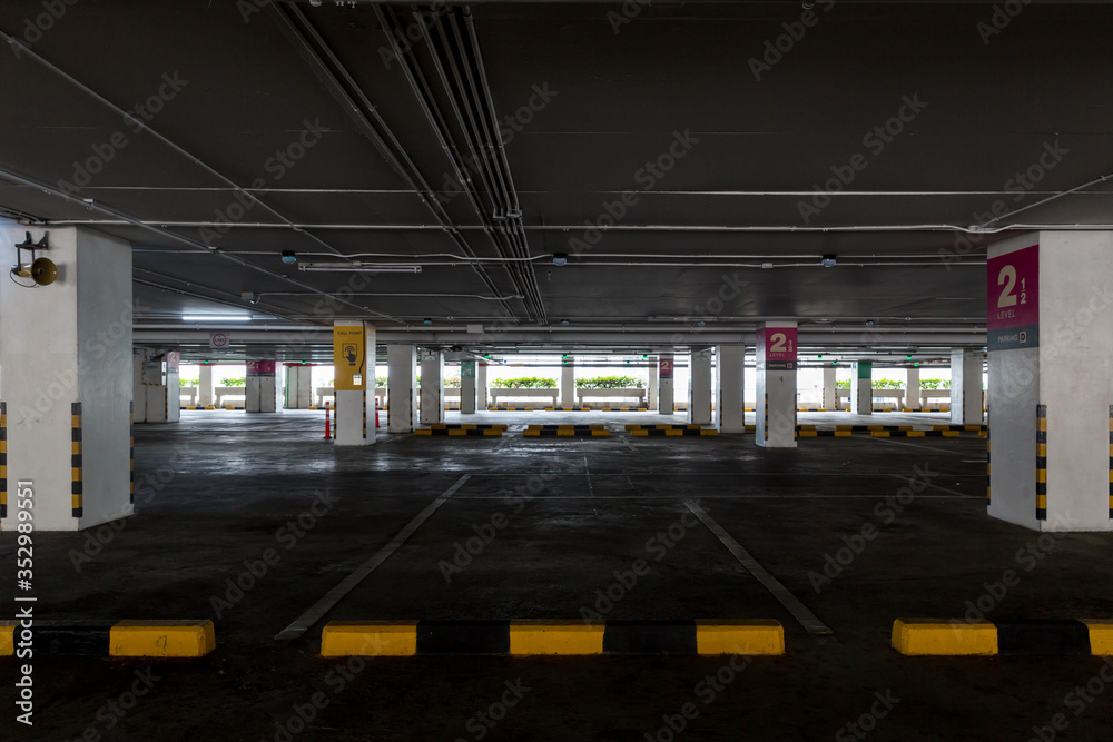 Empty space car park interior at afternoon.Indoor parking lot.interior of parking garage with car and vacant parking lot in parking building.some carpark empty in Condominium or department store. Empty space car park interior at afternoon.Indoor parking lot.interior of parking garage with car and vacant parking lot in parking building.some carpark empty in Condominium or department store.